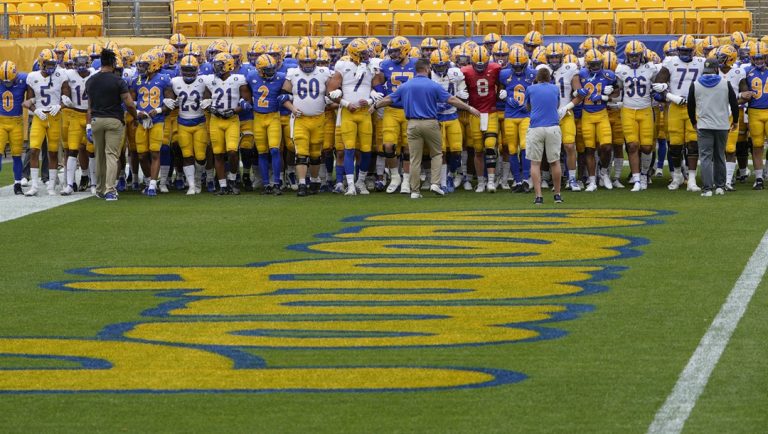The Pittsburgh Panthers football team walks through the end zone as they warm up before their annual NCAA football intrasquad Blue- Gold scrimmage game, Saturday, April 24, 2021, in Pittsburgh.
