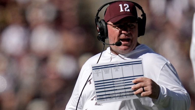 Texas A&M head coach Mike Elko talks to his staff during an injury time out against Samford in the fourth quarter of an NCAA college football game Saturday, Nov. 22, 2025, in College Station, Texas.