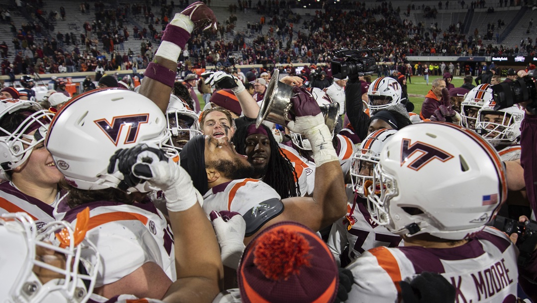 Virginia Tech players drink from the Commonwealth Cup after defeating Virginia 55-17 in an NCAA college football game Saturday, Nov. 25, 2023, in Charlottesville, Va.