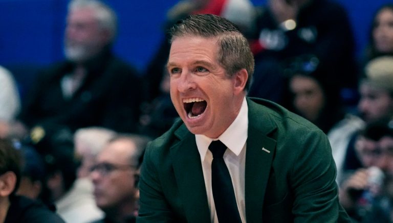 Manhattan head coach John Gallagher calls to his players during the first half of an NCAA college basketball game against UConn, Friday, Nov. 24, 2023, in Hartford, Conn. (AP Photo/Charles Krupa)