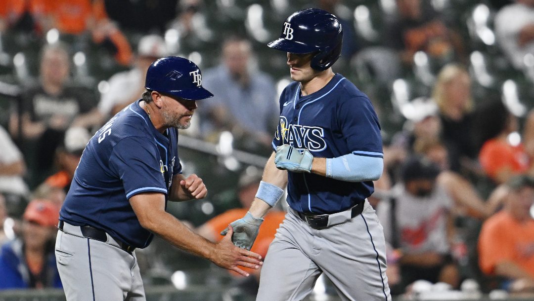 Tampa Bay Rays Jake Mangum is congratulated by third base coach Brady Williams after hitting a solo home run against the Baltimore Orioles in the eighth inning of a baseball game, Wednesday, Sept. 24, 2025, in Baltimore. The Rays won 6-2.