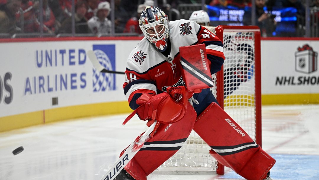 Washington Capitals goaltender Logan Thompson clears the puck during the second period of an NHL hockey game against the Columbus Blue Jackets, Sunday, Dec. 7, 2025, in Washington.