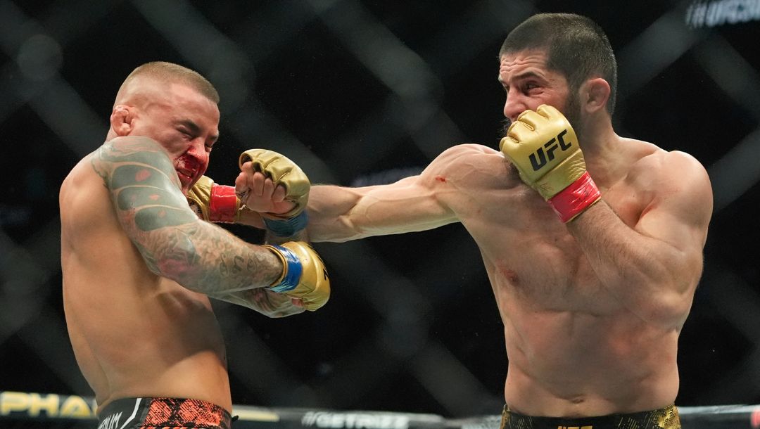Russia's Islam Makhachev, right, punches Dustin Poirier during the third round of a lightweight title bout.