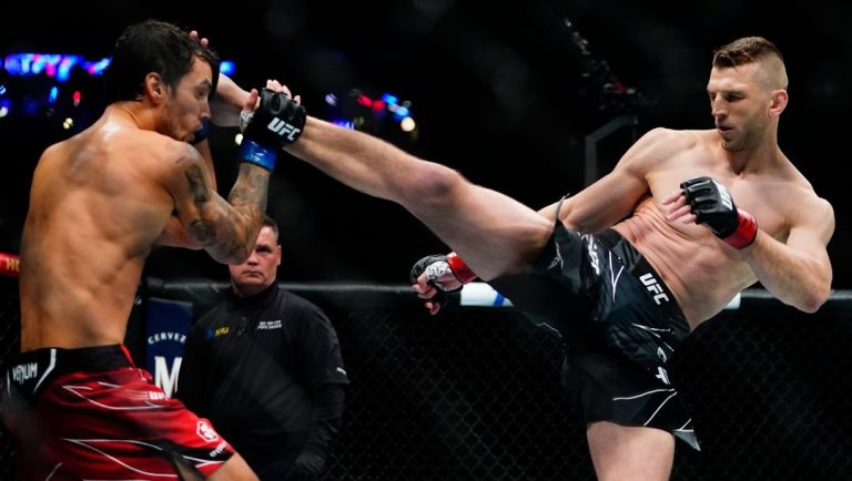 New Zealand's Dan Hooker, right, kicks Peru's Claudio Puelles during the first round of a lightweight bout at the UFC 281.