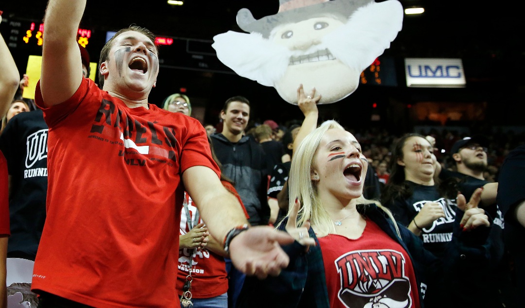 UNLV fans cheer during the second half of an NCAA college basketball game Saturday, Dec. 2, 2017, in Las Vegas. Arizona defeated UNLV 91-88 in overtime. (AP Photo/Isaac Brekken)