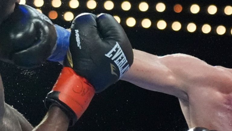 Puerto Rico's Yomar Alamo, right, punches Delante Johnson, left, during their welterweight boxing bout Friday, Sept. 27, 2024.