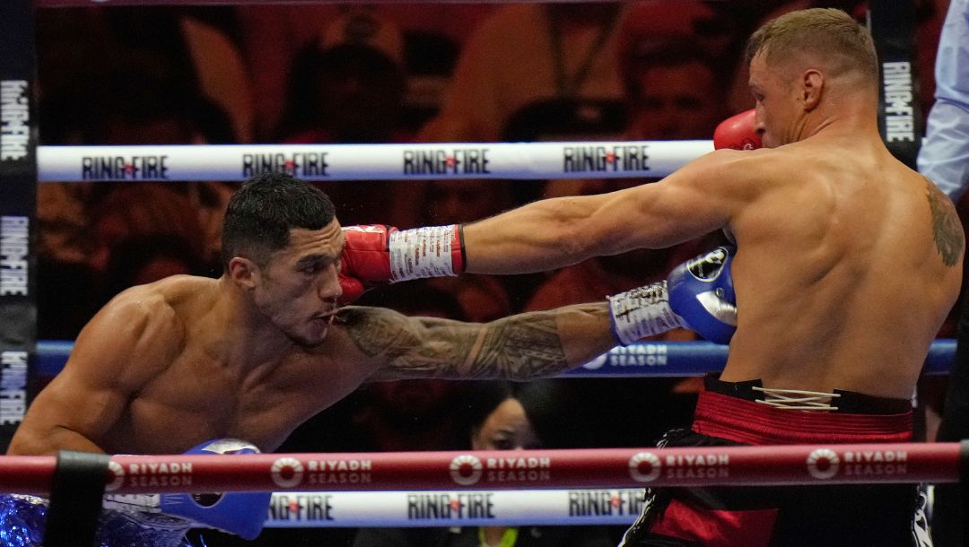 Latvia's Mairis Briedis, right, and Australia's Jai Opetaia trade blows during their boxing fight.