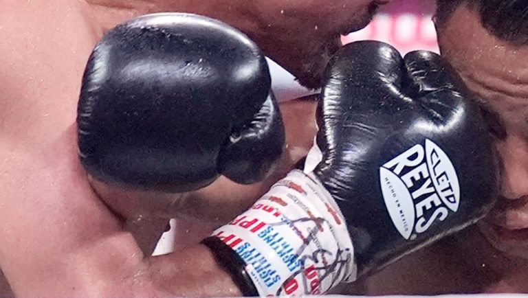 Japanese champion Yoshiki Takei, right, and his compatriot challenger Daigo Higa, left, fight during their boxing match.