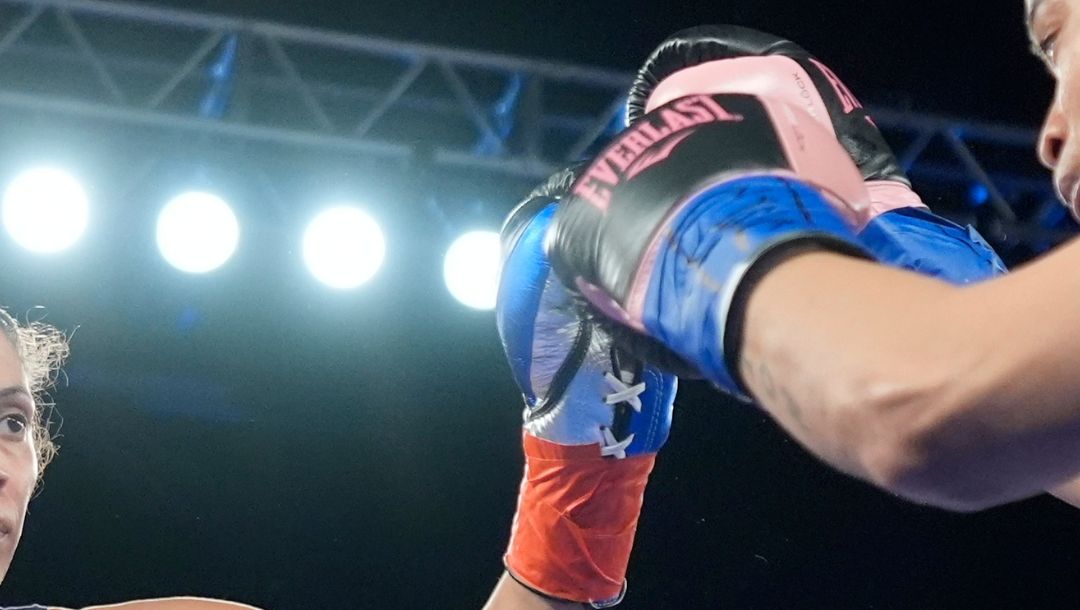 Nisa Rodriguez, left, fights Jozette Cotton during the first round of a women's super middleweight boxing match Friday.