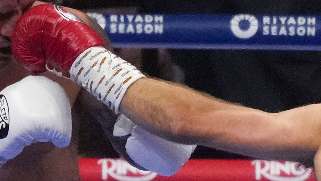 Boxers Isaac Lowe, right, and Lee McGregor compete during their WBC International Featherweight title fight in Riyadh.