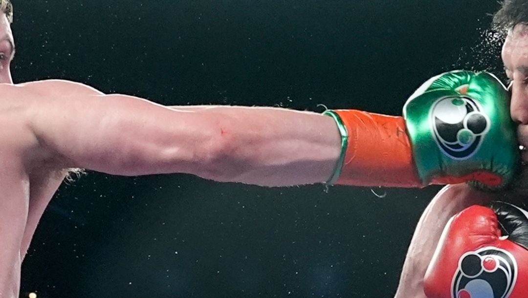 Ireland's Callum Walsh, left, punches Kazakhstan's Dauren Yeleussinov, right, during the seventh round of a super welterweight.