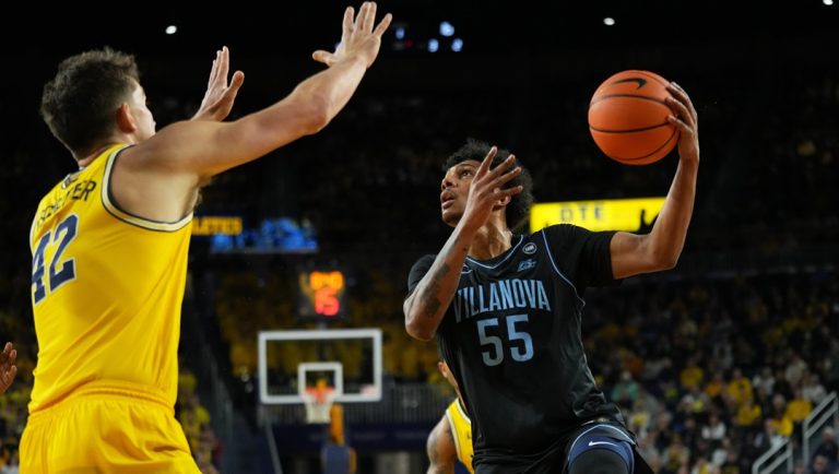 Villanova guard Acaden Lewis, right, shoots against Michigan forward Will Tschetter during the first half of an NCAA college basketball game, Tuesday, Dec. 9, 2025, in Ann Arbor, Mich.