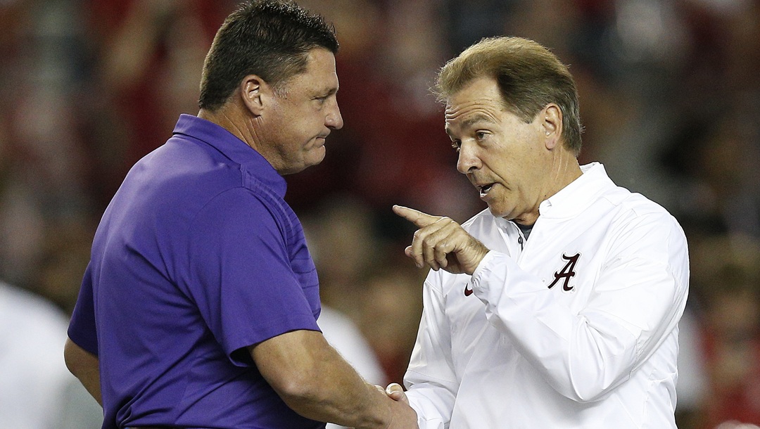 FILE - In this Nov. 4, 2017, file photo, LSU head coach Ed Orgeron, left, and Alabama head coach Nick Saban meet in the center of the field before an NCAA college football game, in Tuscaloosa, Ala. For the first time in college football history, there will be two games matching teams of at least 8-0 on the same day, according to ESPN Facts and Info. In Tuscaloosa, Alabama, LSU and the Crimson Tide will play the first regular-season game matching AP Nos. 1 and 2 since 2011 _ when No. 1 LSU beat No. 2 Alabama 9-6 in overtime. (
