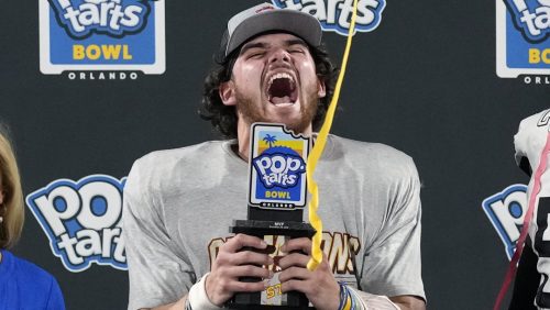 Iowa State quarterback Rocco Becht celebrates with his trophy after being named MVP of the Pop Tarts Bowl NCAA college football game against Miami, Saturday, Dec. 28, 2024, in Orlando, Fla.