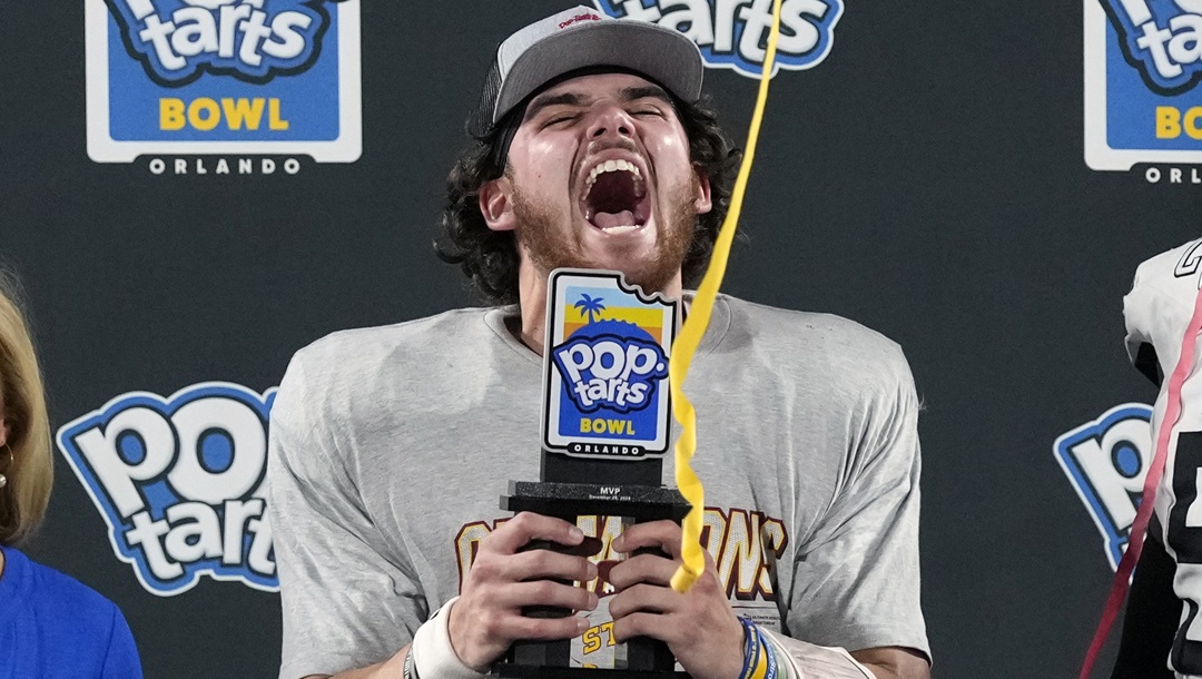 Iowa State quarterback Rocco Becht celebrates with his trophy after being named MVP of the Pop Tarts Bowl NCAA college football game against Miami, Saturday, Dec. 28, 2024, in Orlando, Fla.
