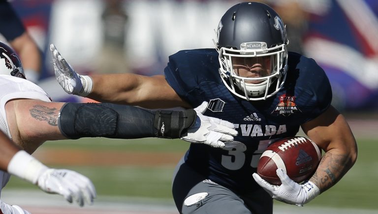 In this Dec. 29, 2018, file photo, Nevada running back Toa Taua (35) carries during the first half of the Arizona Bowl NCAA college football bowl game against Arkansas State in Tucson, Ariz. Nevada sophomore running back Taua rushed for 872 yards and six TDs last year for Nevada. Coming off breakout freshman seasons, Purdue wide receiver Rondale Moore and Nevada's Taua headline Friday night's non-conference opener on the edge of the Sierra where both third-year coaches hope to turn the corner on rebuilding efforts.