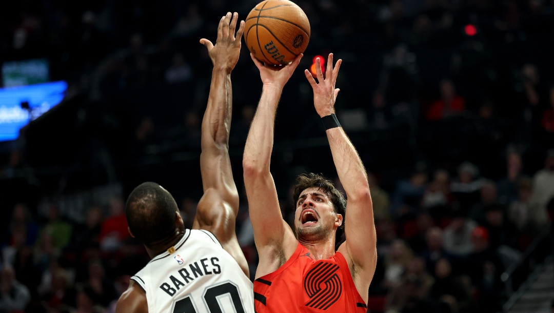 Deni Avdija #8 of the Portland Trail Blazers shoots against Harrison Barnes #40 of the San Antonio Spurs during the first half at Moda Center on November 26, 2025 in Portland, Oregon.