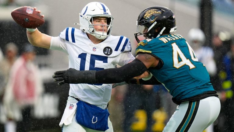 Indianapolis Colts quarterback Riley Leonard (15) looks for a receiver as he is rushed by Jacksonville Jaguars defensive end Travon Walker (44) during the second half of an NFL football game, Sunday, Dec. 7, 2025, in Jacksonville, Fla.