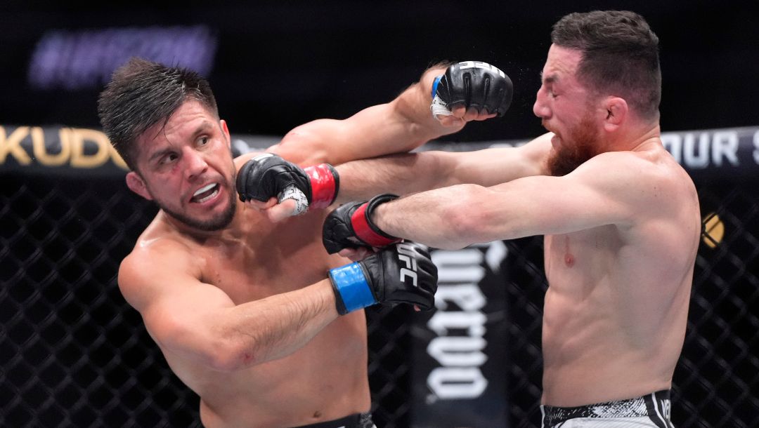 Merab Dvalishvili, right, connects with Henry Cejudo during their bantamweight bout at the UFC 298 mixed martial arts event.