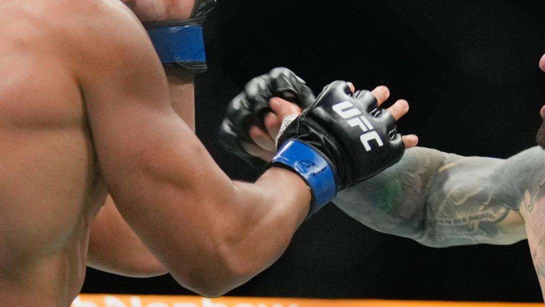 England's Tom Aspinall, right, fight Ciryl Gane, of France, during a heavyweight title bout at the mixed martial arts.