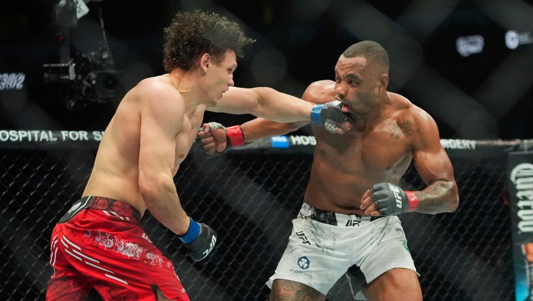 Russia's Roman Kopylov, left, punches Brazil's Cesar Almeida, right, during the third round of a welterweight bout.