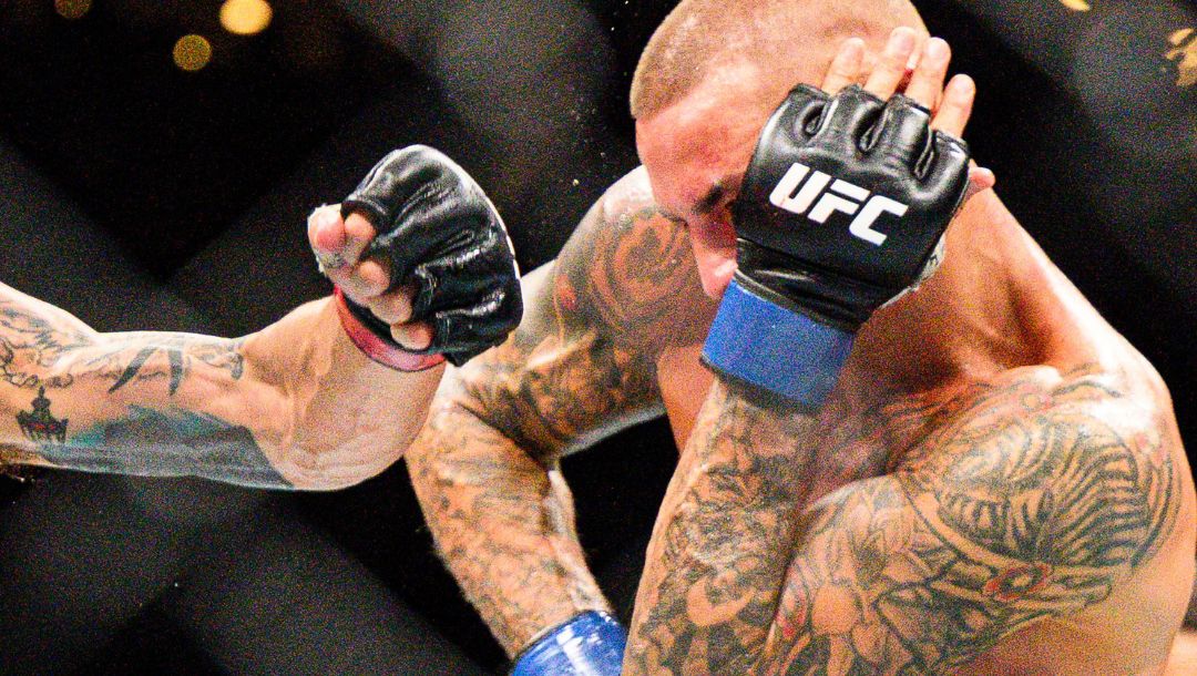 Max Holloway left, hits Dustin Poirier in a lightweight title fight at UFC 318 in New Orleans, La., Saturday, July 19, 2025.