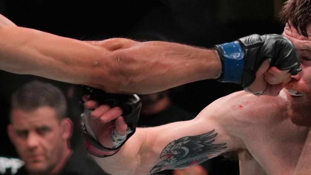 Russia's Umar Nurmagomedov, left, punches Cory Sandhagen, right, of the United States, in the face.