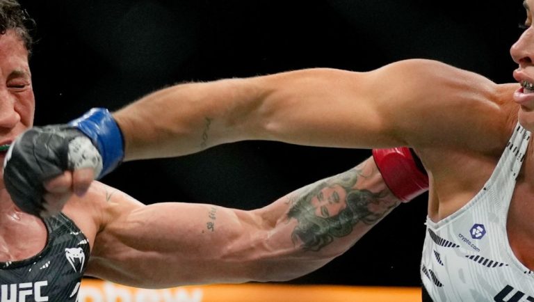 Brazil's Mackenzie Dern, right, punches Virna Jandiroba during women's strawweight title bout at the mixed martial arts.