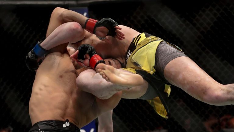 Brazil's Thiago Moises, left, competes against fellow Brazilian Melquizael Costa in a lightweight bout at the UFC 283.