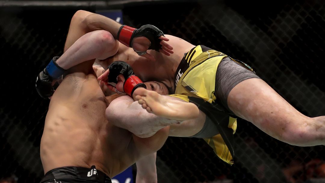 Brazil's Thiago Moises, left, competes against fellow Brazilian Melquizael Costa in a lightweight bout at the UFC 283.