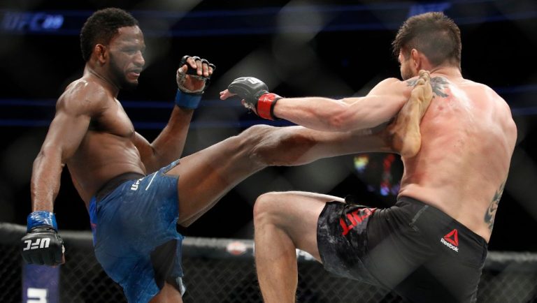 Neil Magny, left, kicks Carlos Condit during a welterweight mixed martial arts bout at UFC 219, Saturday, Dec. 30, 2017.