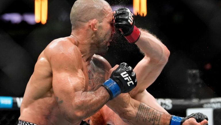 Bo Nickal, right, punches Brazil's Rodolfo Vieira during the second round of a middleweight bout at the UFC 322 mixed martial.